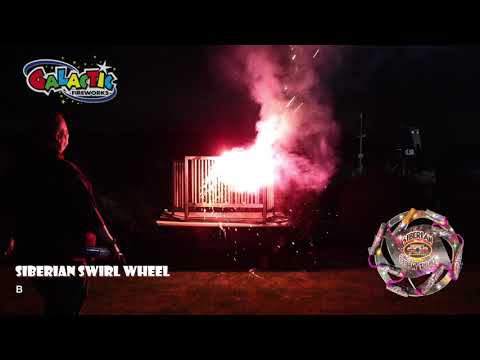 Siberian Swirl 8-motor Catherine Wheel spinning fast with red, yellow, and silver sparks.