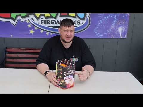 a man sitting at a table with a box of fireworks