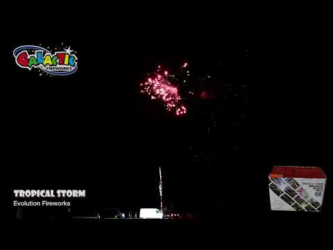 Tropical Storm firework in action at night, showcasing bright red aerial bursts; product box and Galactic Fireworks logo visible in corner.