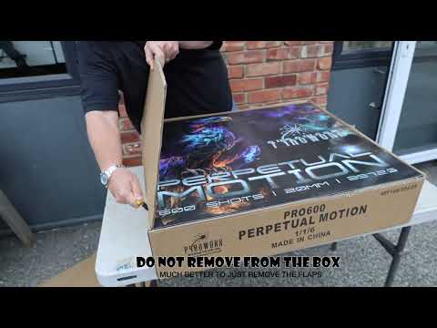 Galactic Fireworks team member standing next to the massive Perpetual Motion box to show scale.