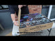 Galactic Fireworks team member standing next to the massive Perpetual Motion box to show scale.