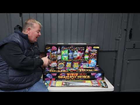 Man presenting the Dealers Choice Firework Selection Box by Primed Pyrotechnics, showcasing its 28 premium fireworks for a complete celebration kit.