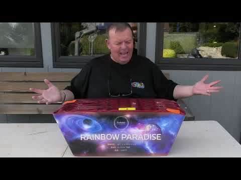 Nigel Turver holding the Rainbow Paradise cake showing the wide "slice" layout.