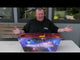 Nigel Turver holding the Rainbow Paradise cake showing the wide "slice" layout.