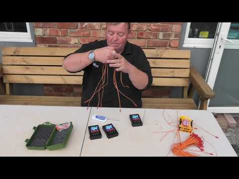 Demonstration of 12 Cue Electric Firing System setup with remote and e-match wiring for wireless firework display control.