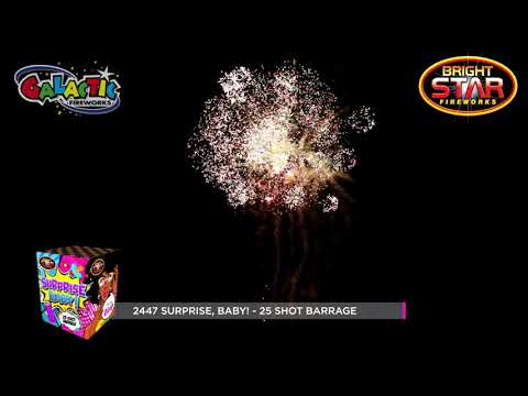 Pink firework bursts in the night sky for a baby girl gender reveal.