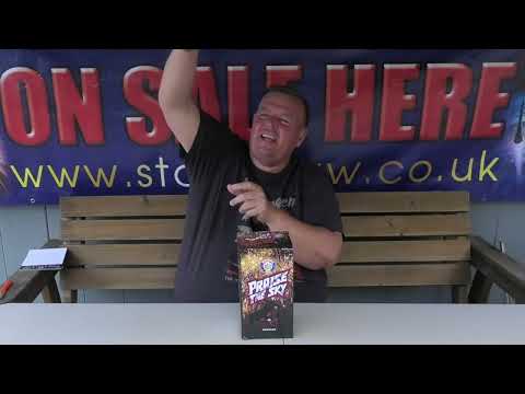 Man presenting Praise The Sky by Brothers Pyrotechnics low noise cake at a fireworks store, highlighting its party-friendly features.
