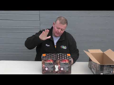 a man standing in front of two boxes of fireworks