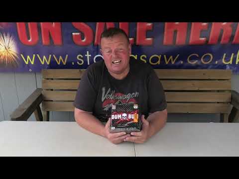 a man sitting at a table with a firework in front of him