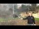 Man demonstrating Cube Fireworks' Black Handheld Smoke Grenade outdoors, releasing thick black smoke for 90 seconds, ideal for special effects.
