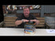 Presenter showcasing Thunder Strike 48-shot firework cake by Bright Star Fireworks on a table, highlighting its size and packaging.