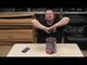 Demonstration of Long Shot 19-Shot Cake by Primed Pyrotechnics, with presenter showcasing the firework on a table before use.