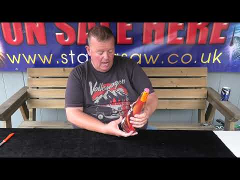 Demonstrator holding the 13" Silver Lava Fountain by Cube Fireworks, showcasing its size and packaging for party and celebration use.