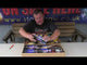 a man sitting at a table in front of a box of fireworks