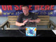 Presenter showcasing Hurricane 36-shot firework cake by Evolution, highlighting its features for party and celebration use.