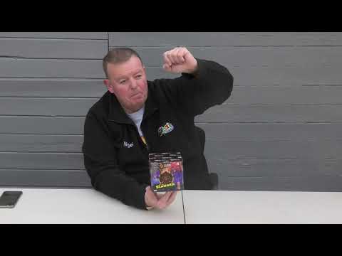 Man presenting the Slammer 25-shot firework cake by Cube Fireworks, highlighting its features for party and celebration use.