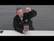 Man presenting the Slammer 25-shot firework cake by Cube Fireworks, highlighting its features for party and celebration use.