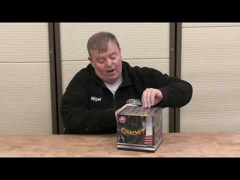 Presenter showcasing Ghost 36-shot cake by Gemstone Fireworks, highlighting packaging and features for party and celebration use.