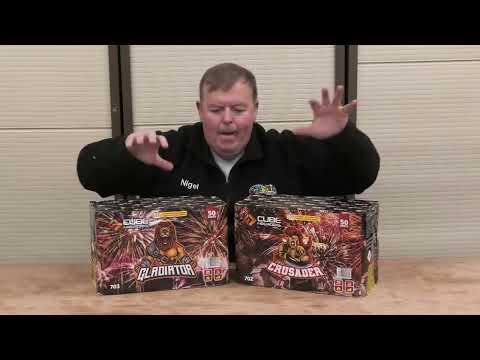 Presenter showcasing Gladiator and Crusader 50-shot fireworks cakes by Cube Fireworks, highlighting features for party and celebration events.