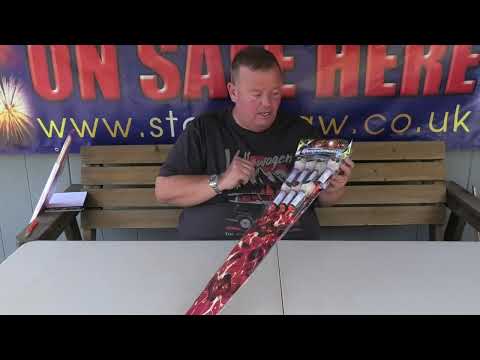 a man sitting at a table holding a packet of rockets